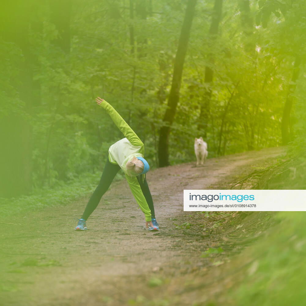 Sporty woman working out in forest. Sporty young female working out in forest. Female runner during outdoor workout in nature. Fitness model outdoors. Weight Loss. Healthy lifestyle., model releasedsport, workout, exercise, active, girl, woman, forest, fit, female, activity, young, person, lifestyle, sporty, recreation, sportswear, stretching, athletic, outside, runner, jogger, leisure, fitness, energy, outdoor, healthy, athlete, woods, park, vitality, jogging, train, one, health, action, motion, adult, cross-country, jog, training, trees, trail, endurance, blonde, nature, running, run, summer, spring, dog,