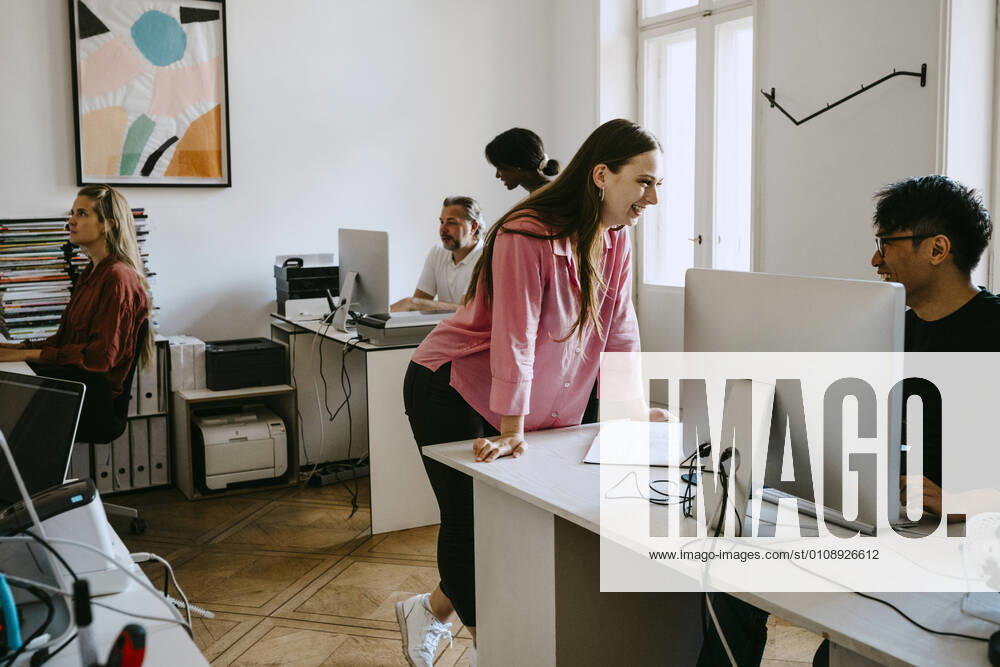 Male and female coworkers working in office Germany, Berlin, model released, property released