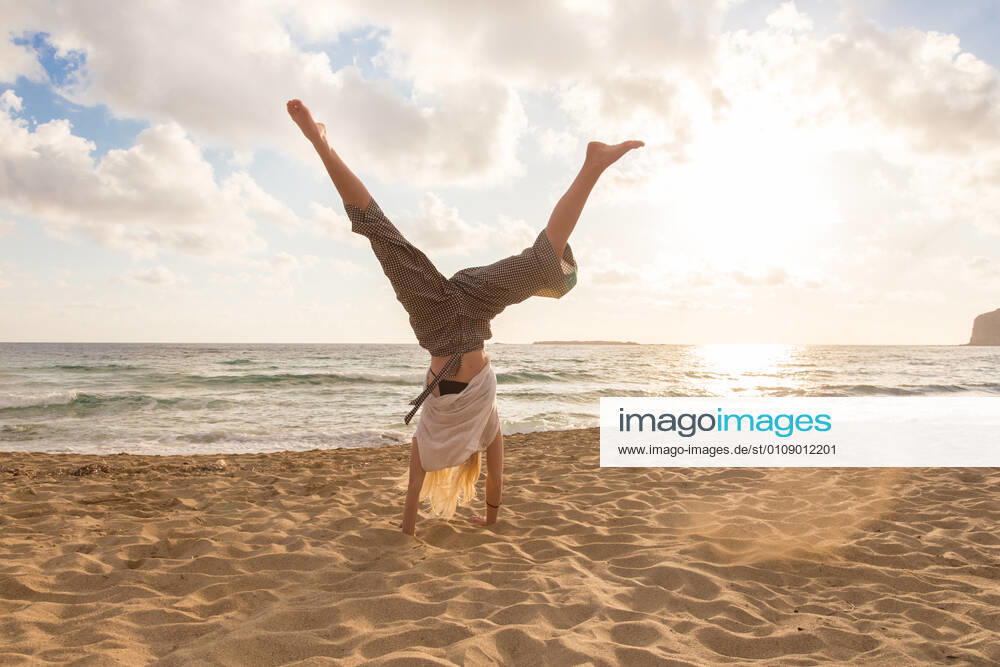Free Happy Woman Turning Cartwheel Enjoying Sunset on Sandy Beach. Relaxed woman enjoying sun, freedom and life turning cartwheel on beautiful beach in sunset. Young lady feeling free, relaxed and happy. Vacations, freedom, happiness, enjoyment and well being., model releasedbeach, woman, cartwheel, sunset, turn, active, sport, sandy, sporty, summer, female, young, sea, fun, joy, nature, relaxation, sand, girl, person, vacation, sun, beauty, outdoors, water, beautiful, alone, activity, holiday, one, paradise, healthy, happy, lifestyle, natural, sunny, sunshine, travel, ocean, sunlight, attractive, seaside, casual, Falasarna, blond, caucasian, peaceful, traquil, golden hour, turning,