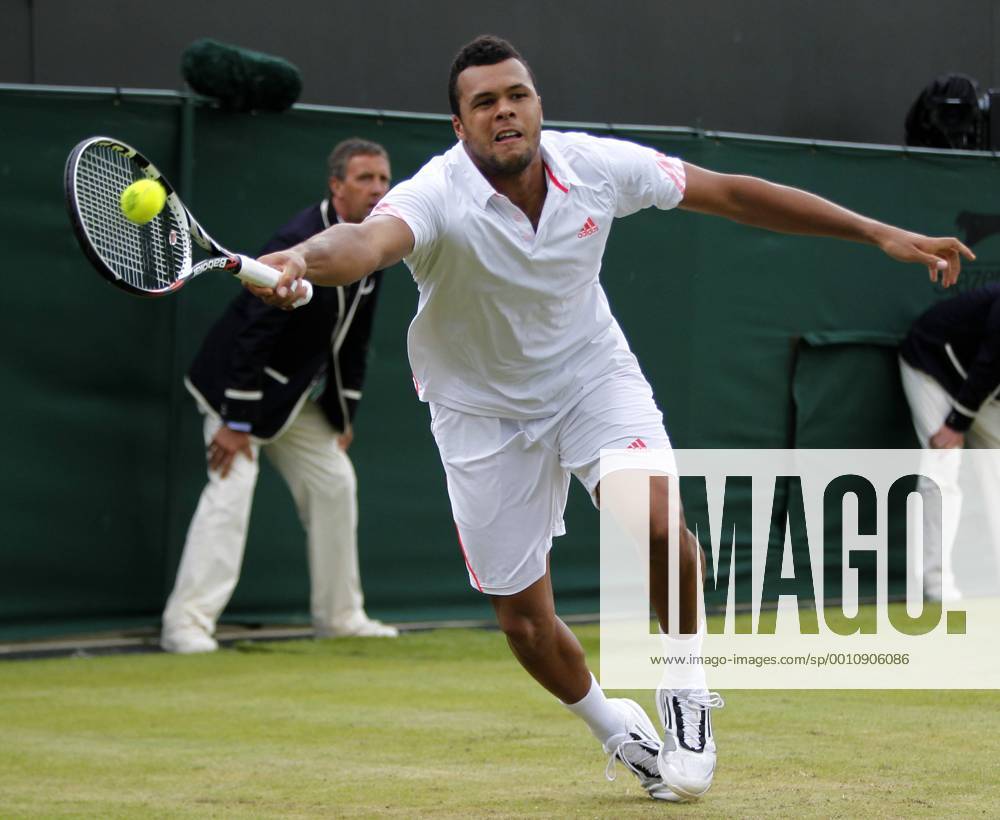 -- Jo-Wilfried Tsonga of France returns the ball during the fourth round match of men s singles at the Wimbledon Championships 2012 in London, Britain on July 3, 2012.