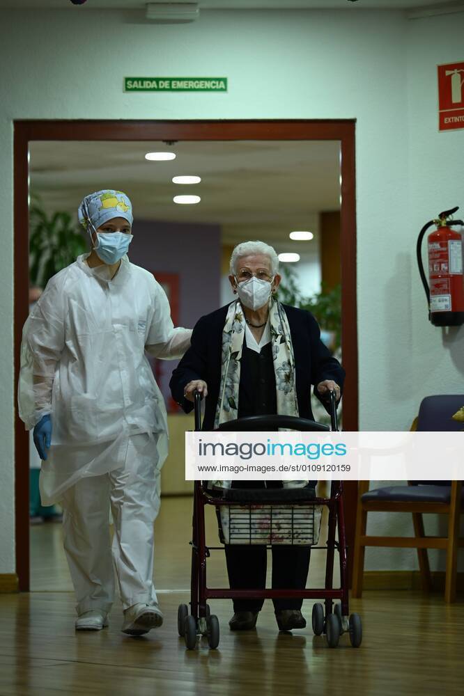 Araceli, 96, accompanied by a nurse, is the first person in Spain to be vaccinated against COVID-19 on the first day of vaccination at the Los Olmos retirement home in Guadalajara, Castilla La-Mancha, Spain, on 27 December 2020. The first doses of the vaccine developed by Pfizer and BioNtech laboratories arrived in Spain yesterday, December 26, at a Pfizer warehouse in Guadalajara by land from Puurs (Belgium). Starting Monday, weekly deliveries will be made to the autonomous communities with an average of 350,000 doses prioritized for four population groups: residents and health and social-health personnel in homes for the elderly and disabled; front-line health personnel; other health and social-health personnel and large non-institutional