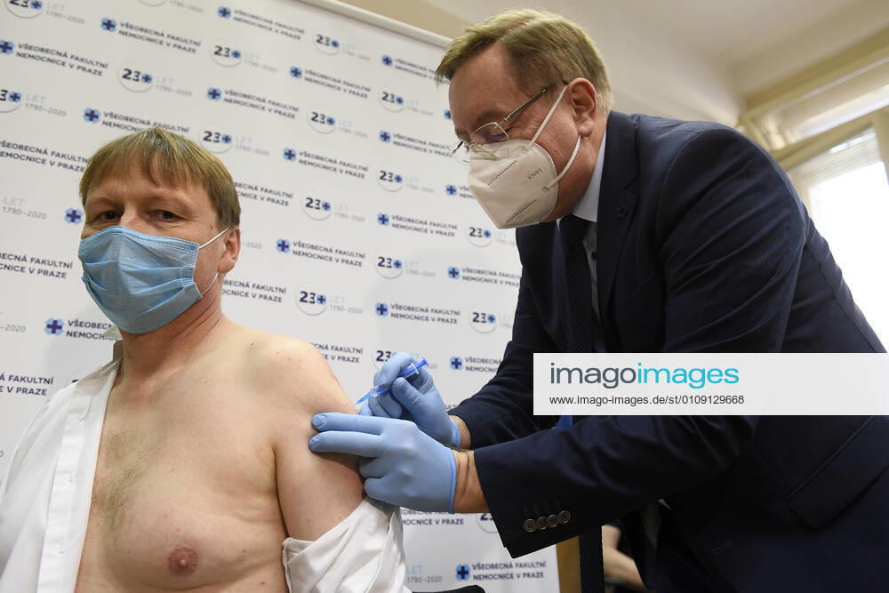 Director of the General University Hospital David Feltl, left, receives vaccine against COVID-19 at the General University Hospital in Prague, Czech Republic, December 27, 2020. At right is director of the University Hospital Kralovske Vinohrady Petr Arenberger. (CTKxPhoto OndrejxDeml) CTKPhotoP202012270246501 dml 001