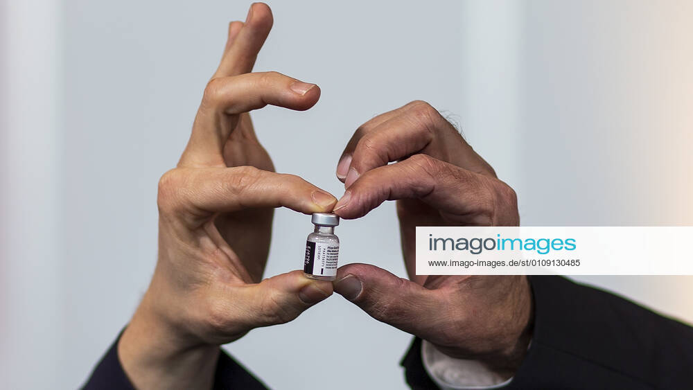 Nuremberg, NuernbergMesse, 27 12 2020, The first Corona vaccinations Picture A vaccine can is held by two different hands