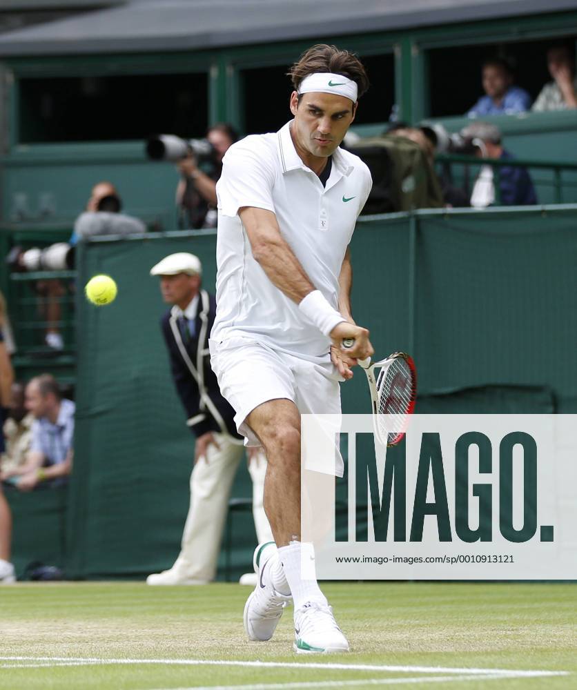 Switzerland s Roger Federer returns in his match on the ninth day of the 2012 Wimbledon championships in London, July 4, 2012. LON2012070416