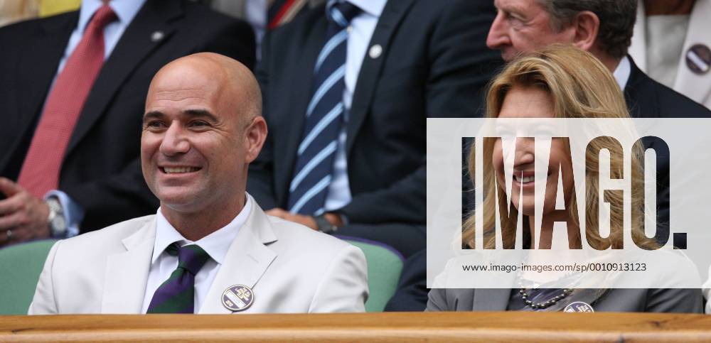 Andre Agassi and his wife Steffi Graf enjoy the tennis in the Royal box on the ninth day of the 2012 Wimbledon championships in London, July 4, 2012. LON2012070419