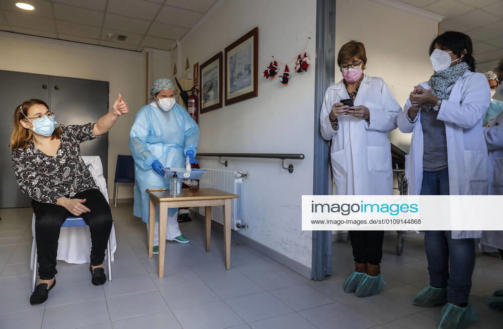 The director of the residence, Josefa Martinez is vaccinated after the Batiste Marti of 81 years, during the first day of vaccination against Covid-19 in Spain, in the residence for elderly Virgen del Milagro de Rafelbunyol, in Valencia (Spain), on December 27, 2020. The first doses of the vaccine developed by Pfizer and BioNtech laboratories arrived in Spain yesterday, December 26, at a Pfizer warehouse in Guadalajara by land from Puurs (Belgium). Starting Monday, weekly deliveries will be made to the autonomous communities with an average of 350,000 doses prioritized for four population groups: residents and health and social-health personnel in homes for the elderly and disabled; front-line health personnel; other health and social-healt