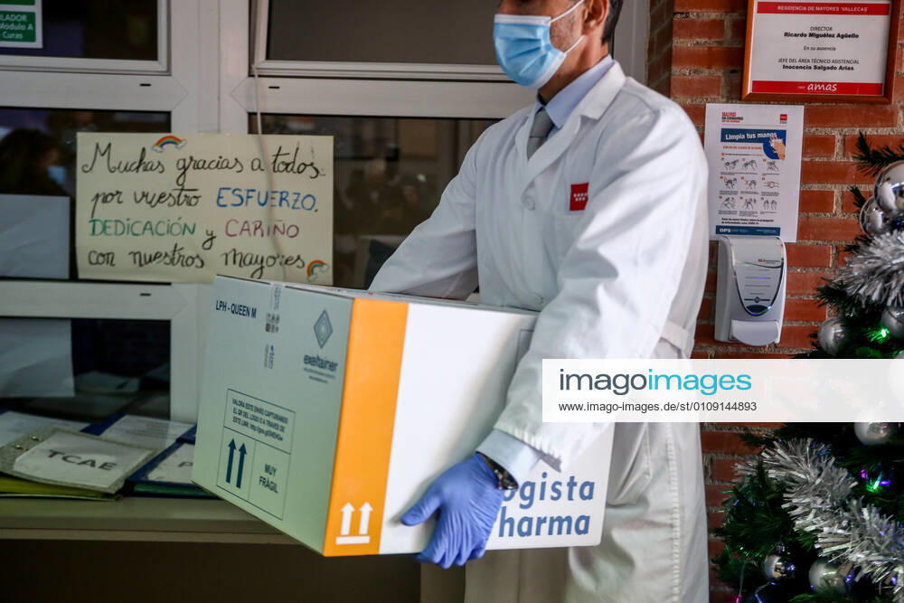 A health worker from the residence collects the box with the doses of the vaccine during the first day of vaccination against Covid-19 in Spain, in the Vallecas residence for the elderly, belonging to the Madrid Agency for Social Care (AMAS), in Madrid (Spain), on 27 December 2020. The first 1,200 doses are administered in two more residences in the capital, the La Azaleas residence of the ASISPA Group in Ciudad Lineal and the Parque Almansa residence of the Ballesol Group in Moncloa Aravaca. The doses of the vaccine developed by Pfizer and BioNtech laboratories arrived in Spain yesterday, December 26th, at a Pfizer warehouse in Guadalajara by land from Puurs (Belgium). From Monday, weekly deliveries will be made to the autonomous communiti