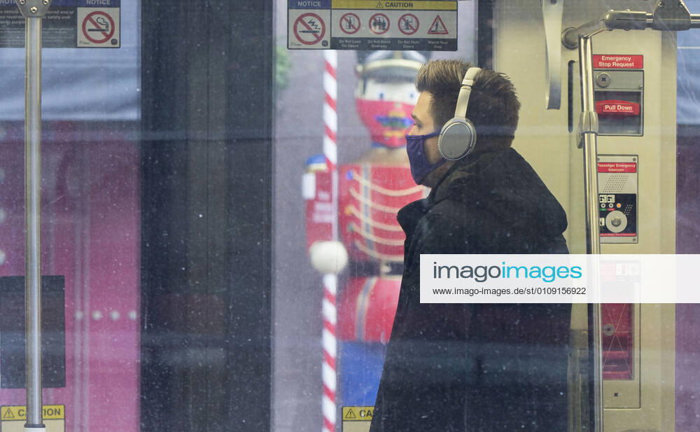 (201228) -- TORONTO, Dec. 28, 2020 -- A man wearing a face mask rides a TTC streetcar in Toronto, Ontario, Canada, Dec. 27, 2020. Canada s COVID-19 cases surpassed 550,000, with the total hitting 552,020, including 14,963 deaths, as of Sunday afternoon, according to CTV. Ontario, the most populous province in Canada, reported 2,005 new cases, bringing its total case count to 171,416 on Sunday. (Photo by Xinhua) CANADA-ONTARIO-COVID-19 ZouxZheng