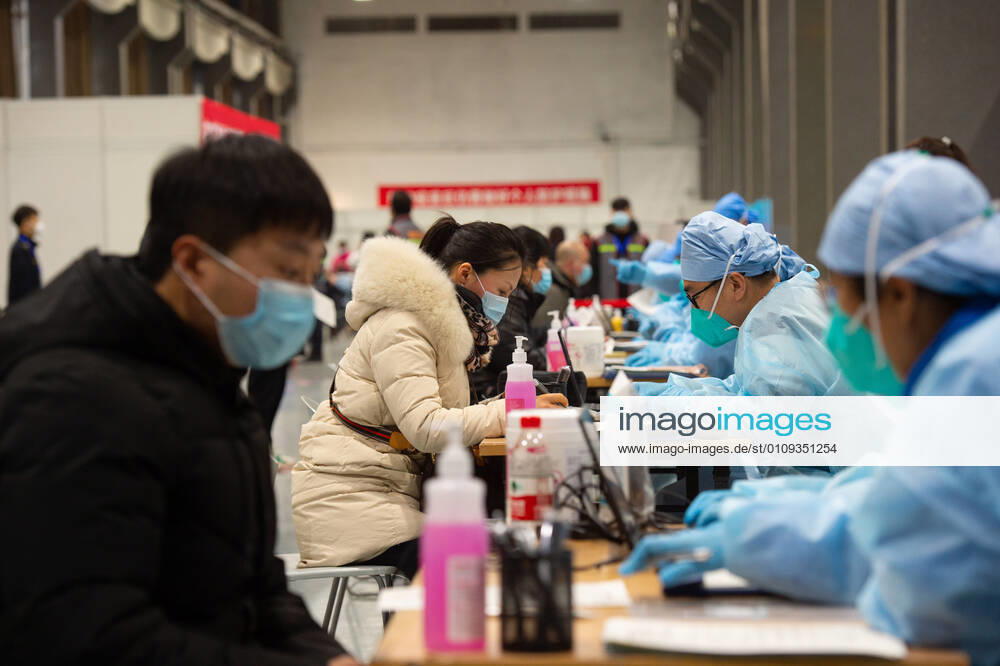 (210102) -- BEIJING, Jan. 2, 2021 -- People fill the informed consent form out before the COVID-19 vaccination at a temporary vaccination site in Beijing, capital of China, Jan. 2, 2021. Beijing started administering COVID-19 vaccines among specific groups of people with higher infection risks. Nine groups of people aged 18 to 59 will receive the vaccine before the Spring Festival of 2021, which falls on Feb. 12. These include frontline customs inspectors of imported cold-chain goods and personnel working in the overseas and domestic transportation sector. ) CHINA-BEIJING-COVID-19-VACCINATION (CN) ChenxZhonghao