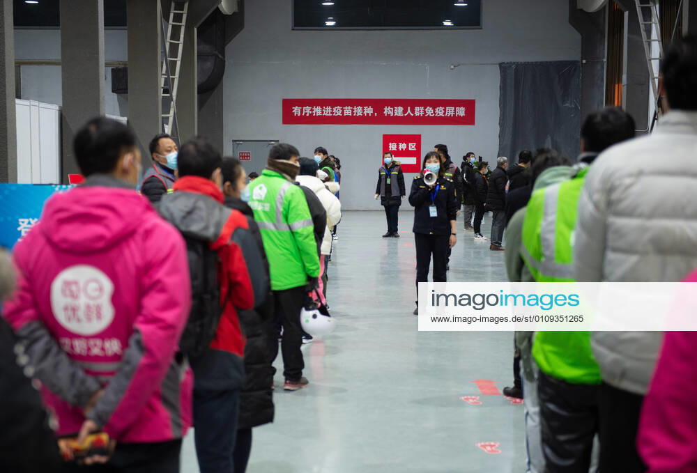 (210102) -- BEIJING, Jan. 2, 2021 -- A staff member (C) leads the way for people waiting for the COVID-19 vaccination at a temporary vaccination site in Beijing, capital of China, Jan. 2, 2021. Beijing started administering COVID-19 vaccines among specific groups of people with higher infection risks. Nine groups of people aged 18 to 59 will receive the vaccine before the Spring Festival of 2021, which falls on Feb. 12. These include frontline customs inspectors of imported cold-chain goods and personnel working in the overseas and domestic transportation sector. ) CHINA-BEIJING-COVID-19-VACCINATION (CN) ChenxZhonghao