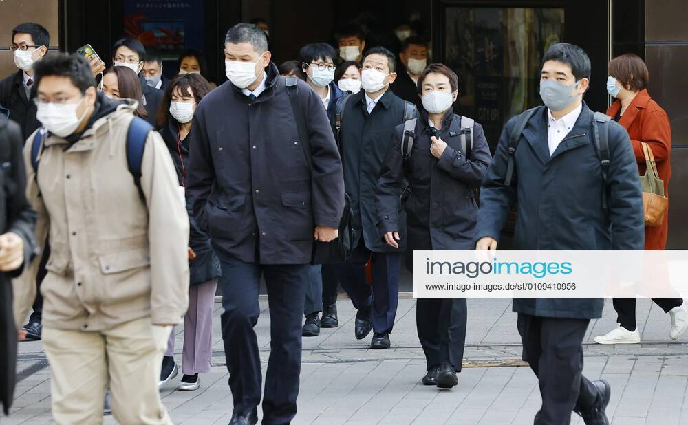 Year s first work in Japan Commuters wearing face masks walk near JR Shimbashi Station in Tokyo on the first work day of the year on Jan. 4, 2021, amid the coronavirus pandemic.