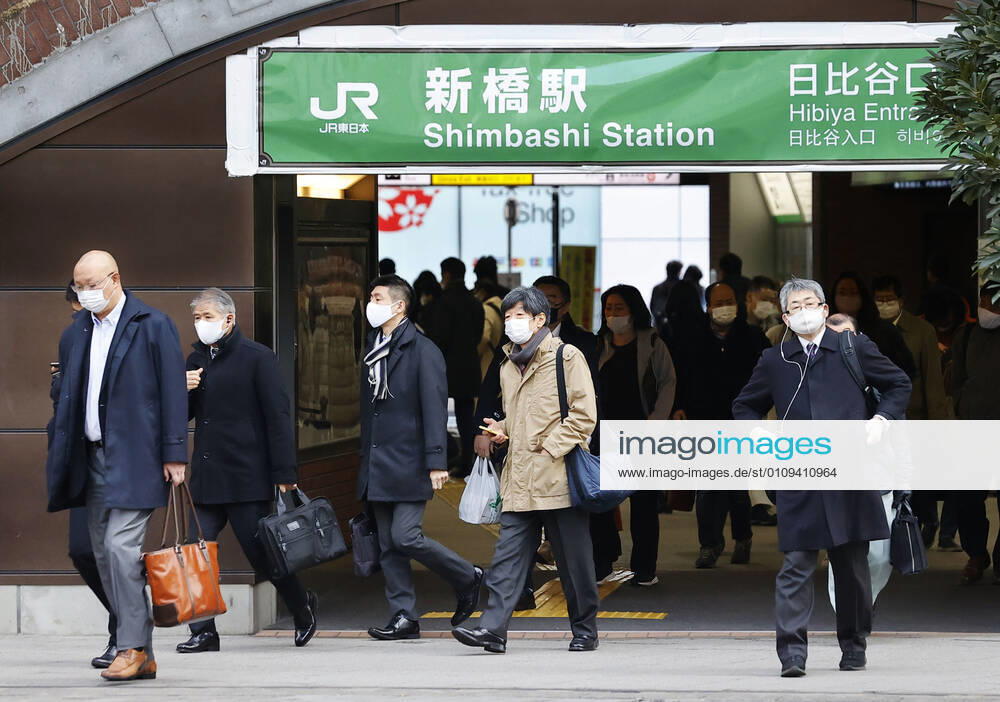 Year s first work in Japan Commuters wearing face masks walk near JR Shimbashi Station in Tokyo on the first work day of the year on Jan. 4, 2021, amid the coronavirus pandemic.