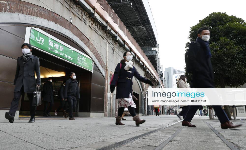 Year s first work in Japan Commuters wearing face masks walk near JR Shimbashi Station in Tokyo on the first work day of the year on Jan. 4, 2021, amid the coronavirus pandemic.