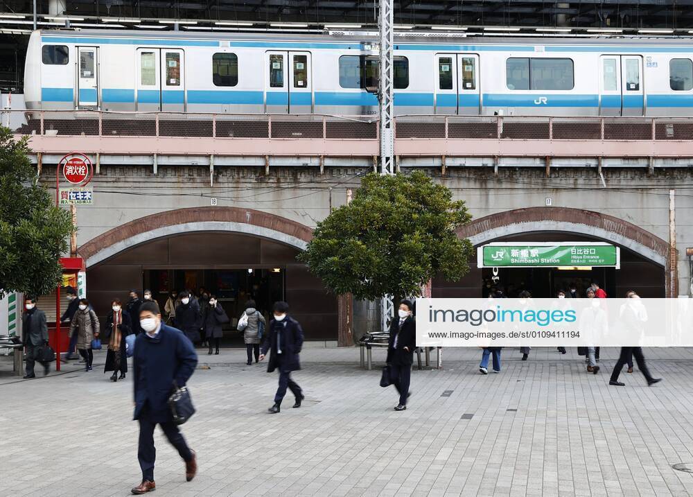 Year s first work in Japan Commuters wearing face masks walk near JR Shimbashi Station in Tokyo on the first work day of the year on Jan. 4, 2021, amid the coronavirus pandemic.
