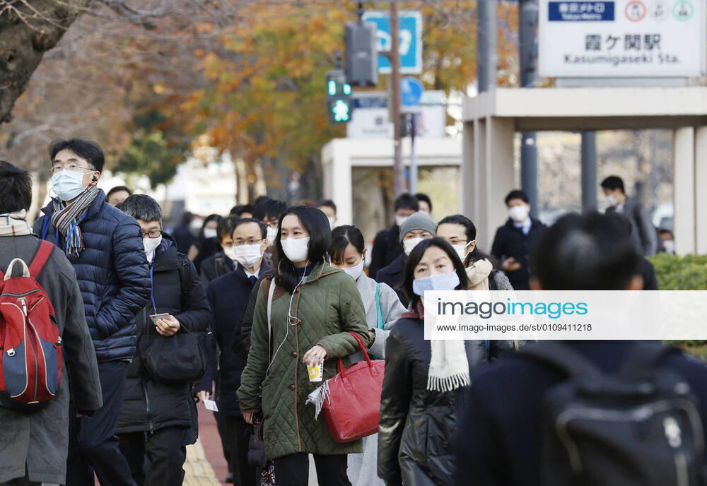 Year s first work in Japan Commuters wearing face masks walk in Tokyo s Kasumigaseki area on the first work day of the year on Jan. 4, 2021, amid the coronavirus pandemic.