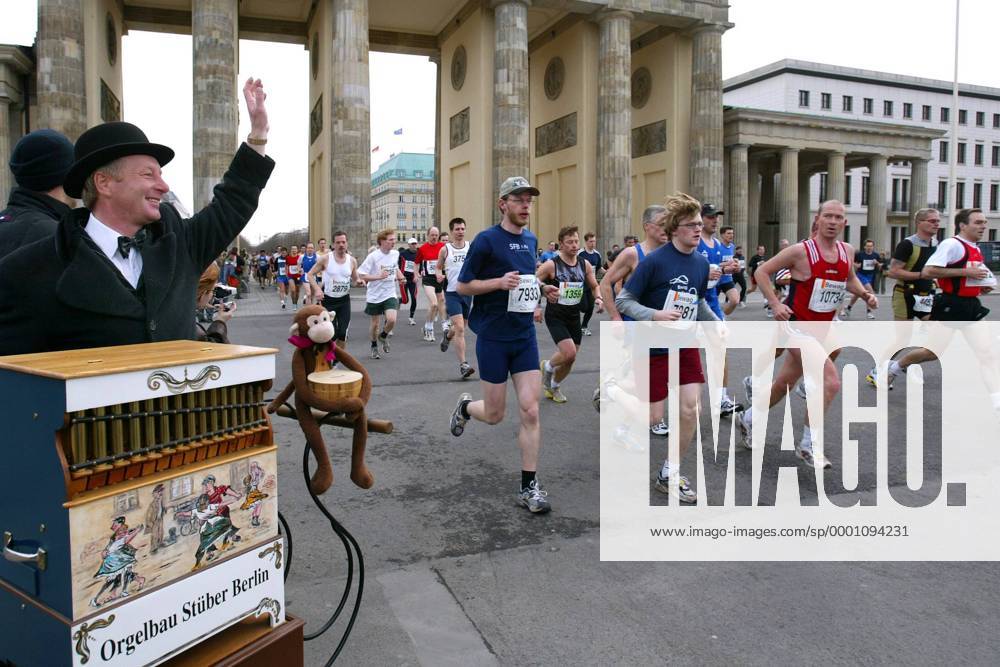 Ein Leierkastenmann begrüßt die Läufer des 24. Berliner Halbmarathons 2004 am Brandenburger Tor Leichtathletik Herren 24. Berliner Halbmarathon 2004, Halb-Marathon, Straßenlauf, Volkslauf, Citymarathon, Vdig Totale Stadtmarathon, Langstrecke Berlin Freude,