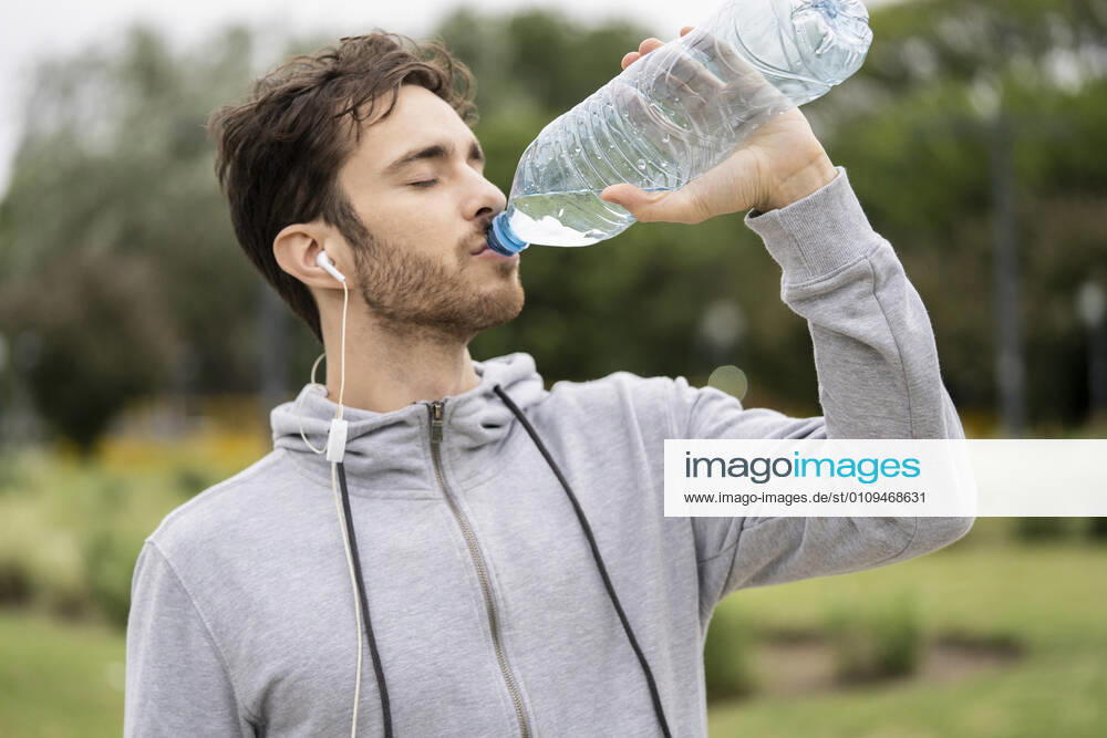 Young man drinking water