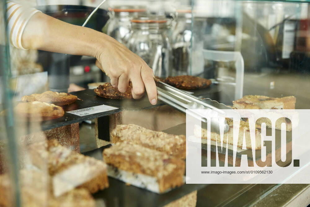 Close up of tongs selecting a slice of cake in cafe Cafe,United Kingdom,Close up of tongs selecting a slice of cake in cafe Close up of tongs selecting a slice of cake in cafe
