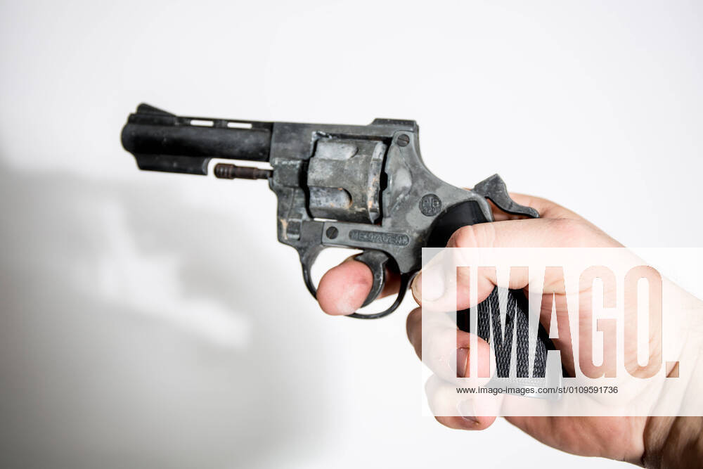 Bamberg, Germany 06 November 2020 symbol pictures 2020 A hand holding a revolver against a white background, feature symbol symbol photo characteristic detail Bavaria