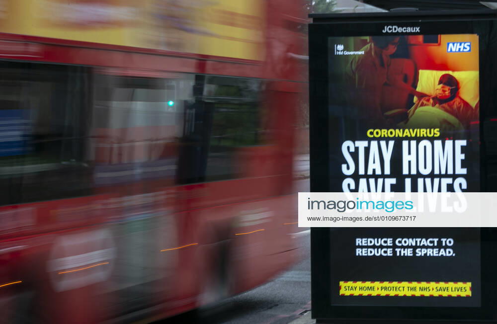 (210110) -- LONDON, Jan. 10, 2021 -- A bus drives past an advertising board reading Stay Home Save Lives in London, Britain, Jan. 10, 2021. The coronavirus-related deaths in Britain surpassed 80,000 on Saturday with another 1,035 reported in the country. ) BRITAIN-LONDON-COVID-19-CASES HanxYan