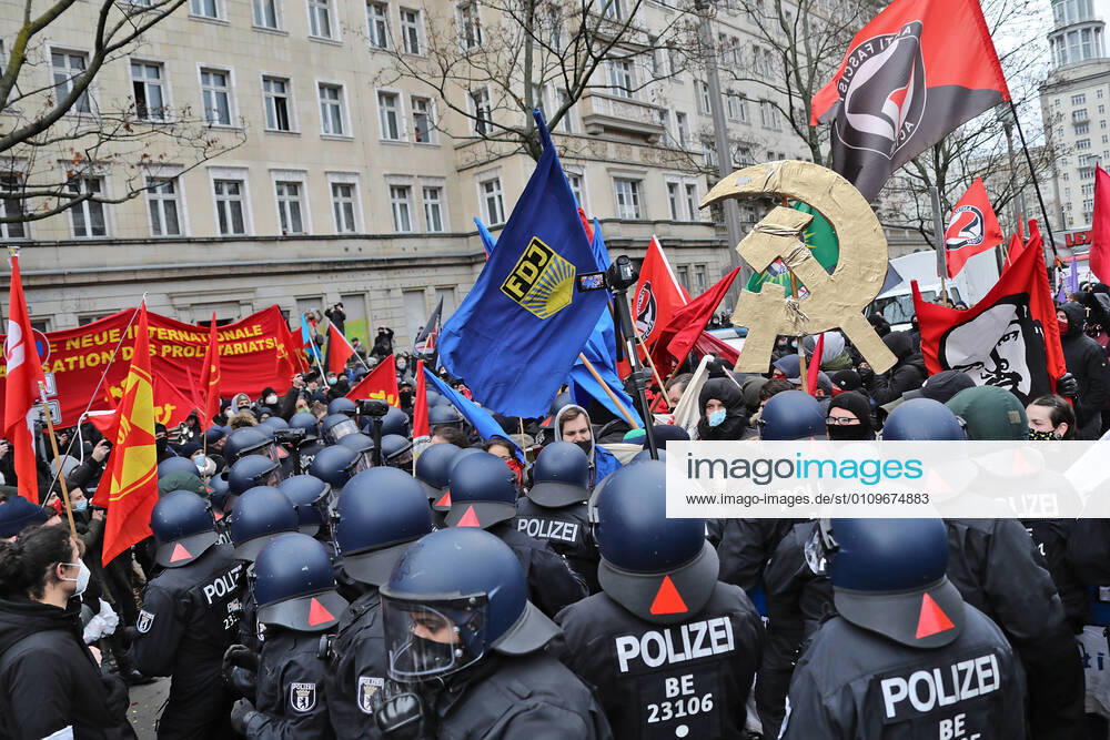 Luxemburg and Liebknecht demonstration 10 1 2021 police gather under FDJ flag and hammer and sickle in gold Berlin Berlin GER