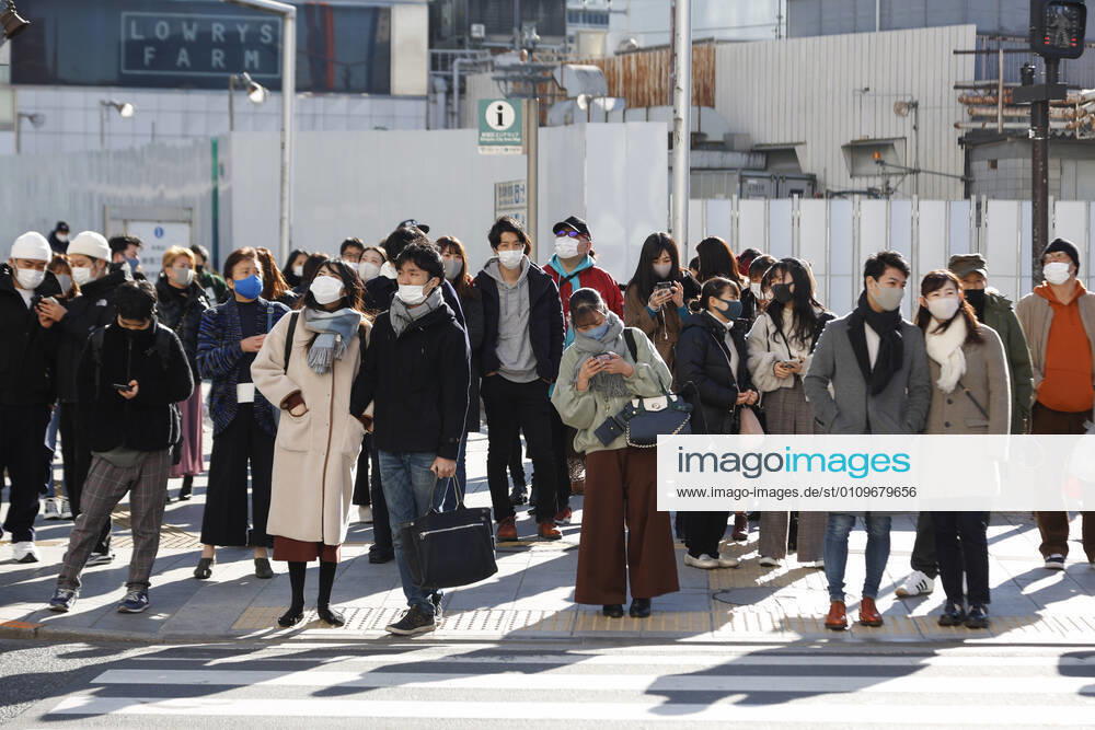 Pedestrians wearing face masks wait to cross a road in Tokyo s Shinjuku ward. Tokyo reported 1,494 new COVID-19 cases on January 10; following four days of over 2,000 cases, the daily infections count dropped for the first time after the state of emergency was declared in Tokyo, Kanagawa, Saitama, and Chiba prefectures. Tokyo Japan - ZUMAm191 20210110_zap_m191_005