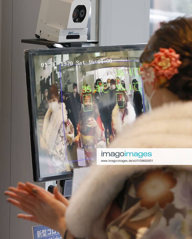 Coming-of-age ceremony under virus state of emergency A woman has her temperature checked before entering the venue of a coming-of-age ceremony in Tokyo s Suginami Ward on Jan. 11, 2021, as the capital is under a coronavirus state of emergency.