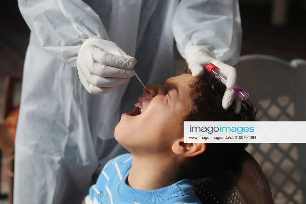 (210111) -- RAFAH, Jan. 11, 2021 -- A medical worker collects a swab sample from a boy to test for the COVID-19 in the southern Gaza Strip city of Rafah, Jan. 11, 2021. (Photo by Xinhua) MIDEAST-GAZA-RAFAH-COVID-19-TEST KhaledxOmar