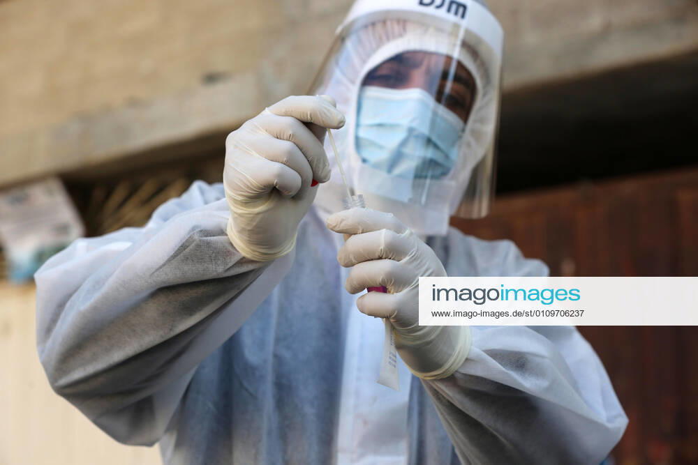 Deir Al-Balah, Gaza Strip, Palestinian Territory: A Palestinian medical worker wearing protective gear, takes a random swab sample for COVID-19 testing inside a mosque, in Deir al-Balah, central of Gaza Strip, on January 11, 2021. The Palestinian Authority (PA) has said it expects to receive its first COVID-19 vaccine doses in March under a deal with British drug giant AstraZeneca, and accused Israel of ignoring its responsibilities to ensure vaccines are available in occupied territory Deir Al-Balah Palestinian Territory - ZUMAap3_ 20210111_zaf_ap3_033