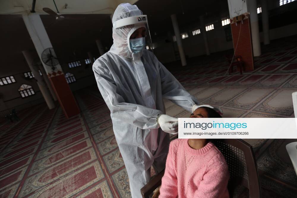 Deir Al-Balah, Gaza Strip, Palestinian Territory: A Palestinian medical worker wearing protective gear, takes a random swab sample for COVID-19 testing inside a mosque, in Deir al-Balah, central of Gaza Strip, on January 11, 2021. The Palestinian Authority (PA) has said it expects to receive its first COVID-19 vaccine doses in March under a deal with British drug giant AstraZeneca, and accused Israel of ignoring its responsibilities to ensure vaccines are available in occupied territory Deir Al-Balah Palestinian Territory - ZUMAap3_ 20210111_zaf_ap3_036