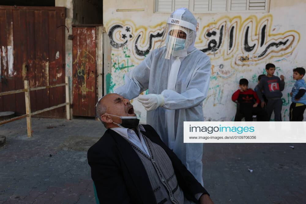 Deir Al-Balah, Gaza Strip, Palestinian Territory: A Palestinian medical worker wearing protective gear, takes a random swab sample for COVID-19 testing, in Deir al-Balah, central of Gaza Strip, on January 11, 2021. The Palestinian Authority (PA) has said it expects to receive its first COVID-19 vaccine doses in March under a deal with British drug giant AstraZeneca, and accused Israel of ignoring its responsibilities to ensure vaccines are available in occupied territory Deir Al-Balah Palestinian Territory - ZUMAap3_ 20210111_zaf_ap3_048