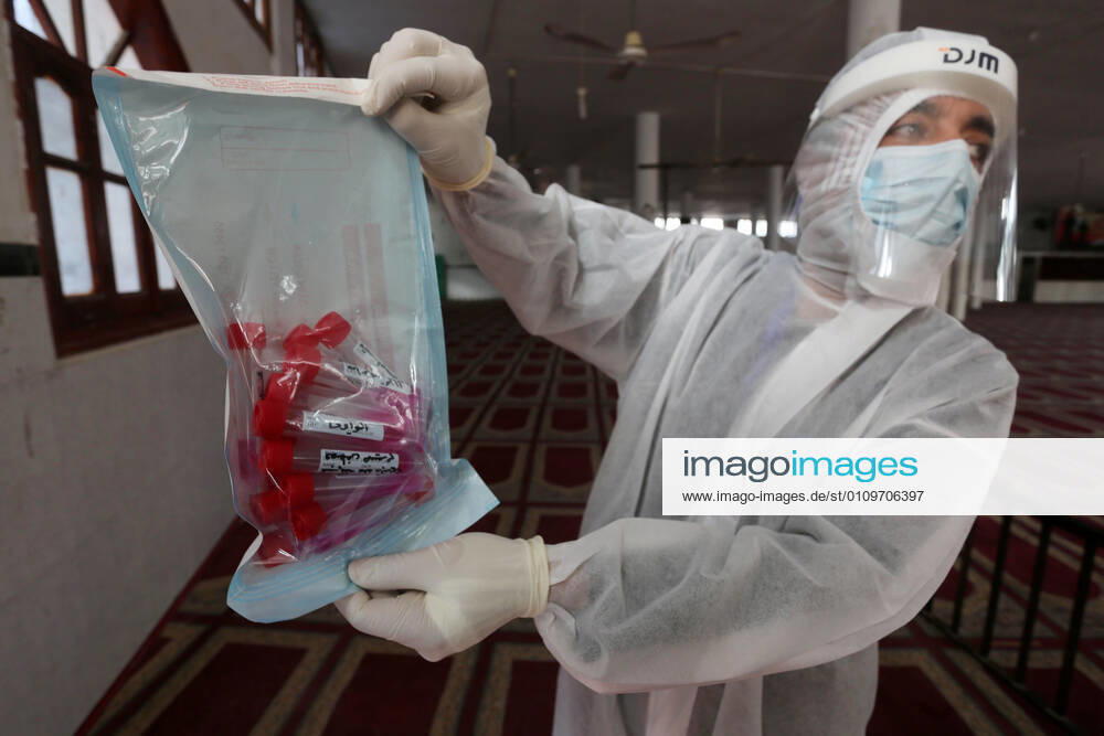Deir Al-Balah, Gaza Strip, Palestinian Territory: A Palestinian medical worker wearing protective gear, takes a random swab sample for COVID-19 testing inside a mosque, in Deir al-Balah, central of Gaza Strip, on January 11, 2021. The Palestinian Authority (PA) has said it expects to receive its first COVID-19 vaccine doses in March under a deal with British drug giant AstraZeneca, and accused Israel of ignoring its responsibilities to ensure vaccines are available in occupied territory Deir Al-Balah Palestinian Territory - ZUMAap3_ 20210111_zaf_ap3_060