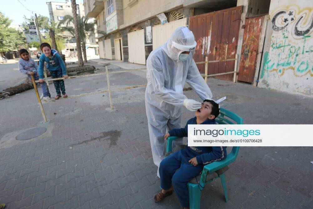 Deir Al-Balah, Gaza Strip, Palestinian Territory: A Palestinian medical worker wearing protective gear, takes a random swab sample for COVID-19 testing, in Deir al-Balah, central of Gaza Strip, on January 11, 2021. The Palestinian Authority (PA) has said it expects to receive its first COVID-19 vaccine doses in March under a deal with British drug giant AstraZeneca, and accused Israel of ignoring its responsibilities to ensure vaccines are available in occupied territory Deir Al-Balah Palestinian Territory - ZUMAap3_ 20210111_zaf_ap3_069