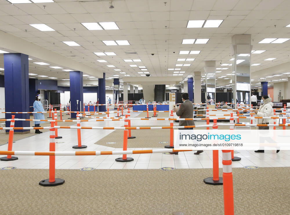 People arrive and get checked in to receive a coronavirus vaccine at an Essex County COVID-19 Vaccination Site located at a closed Sears retail store in the Livingston Mall in Livingston, New Jersey on Monday, January 11, 2021. Public health agencies and health-care groups are using the retailer s empty stores to deliver Vaccines in several locations around parts of the United States. NYP20210111110 JohnxAngelillo