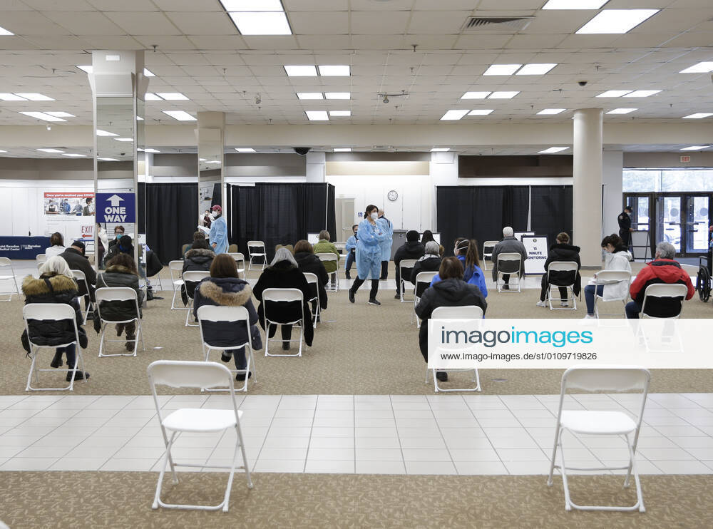 People arrive and get checked in to receive a coronavirus vaccine at an Essex County COVID-19 Vaccination Site located at a closed Sears retail store in the Livingston Mall in Livingston, New Jersey on Monday, January 11, 2021. Public health agencies and health-care groups are using the retailer s empty stores to deliver Vaccines in several locations around parts of the United States. NYP20210111117 JohnxAngelillo
