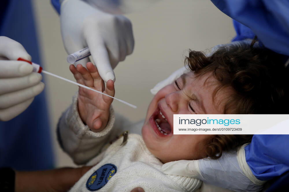 (210111) -- BEIRUT, Jan. 11, 2021 -- A health worker collects a COVID-19 PCR swab from a child at a hospital in Beirut, Lebanon, on Jan. 11, 2021. Lebanon s Higher Defense Council declared on Monday a state of emergency between Jan. 14-25 that includes a total lockdown in hope to restrict further spread of COVID-19, Al-Jadeed local TV channel reported. ) LEBANON-BEIRUT-COVID-19-STATE OF EMERGENCY BilalxJawich