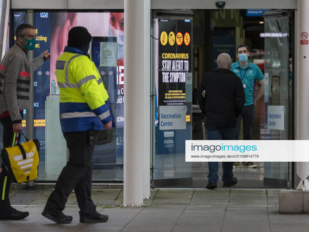 (210113) -- LONDON, Jan. 13, 2021 -- People walk into the Vaccination Centre at ExCel exhibition centre in London, Britain, on Jan. 12, 2021. British Prime Minister Boris Johnson on Monday warned against false complacency as the country is seeking to speed up the coronavirus vaccine rollout. According to the prime minister, 2.4 million coronavirus jabs have been administered across Britain. Seven new mass vaccination sites in England opened Monday, as the country races against time to bring the pandemic under control. ) BRITAIN-LONDON-COVID-19-VACCINE ROLLOUT HanxYan