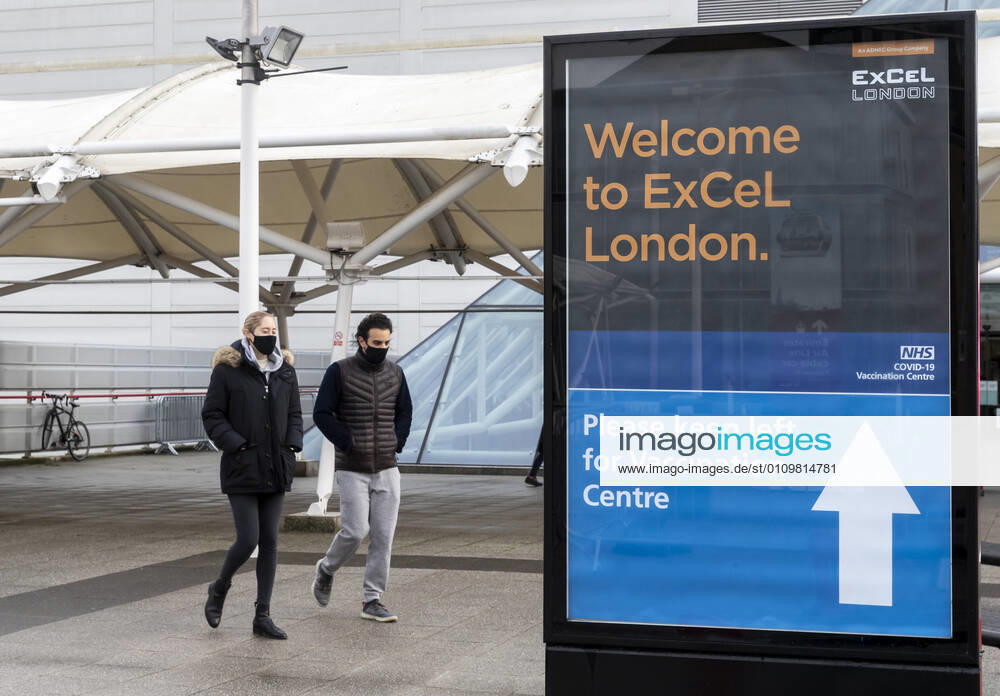 (210113) -- LONDON, Jan. 13, 2021 -- People wearing face masks walk past the Vaccination Centre at ExCel exhibition centre in London, Britain, Jan. 12, 2021. British Prime Minister Boris Johnson on Monday warned against false complacency as the country is seeking to speed up the coronavirus vaccine rollout. According to the prime minister, 2.4 million coronavirus jabs have been administered across Britain. Seven new mass vaccination sites in England opened Monday, as the country races against time to bring the pandemic under control. ) BRITAIN-LONDON-COVID-19-VACCINE ROLLOUT HanxYan