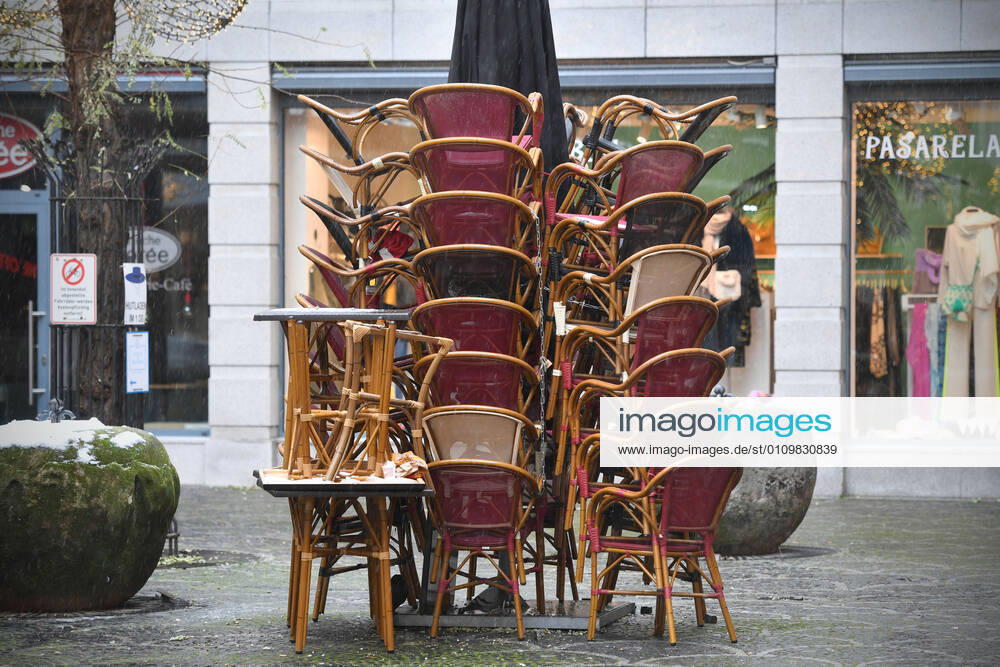 Theme picture Coronavirus pandemic consequences for the gastronomy stacked chairs and tables in the outdoor area of a restaurant in Munich on 12 01 2021