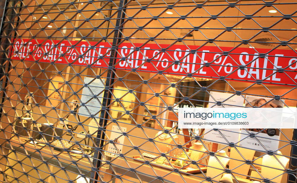 On the window of a closed shop in the city centre of Hamburg a sale is advertised Altstadt Hamburg