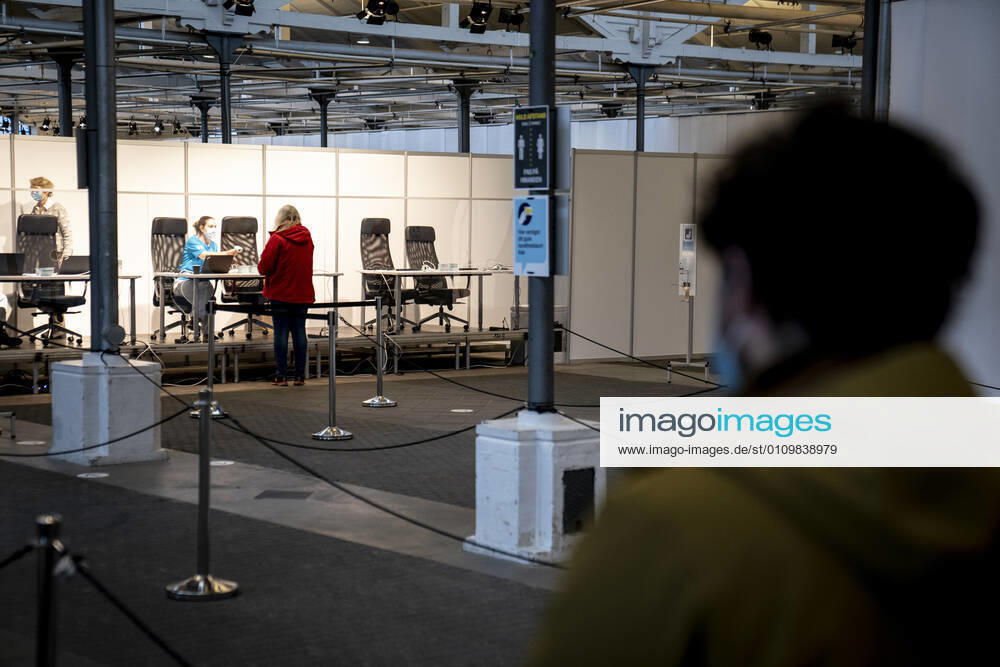 People stand in line in connection with the first vaccine center in the Capital Region opening in OEksnehallen, at Halmtorvet in Copenhagen, Wednesday 13 January 2021, Copenhagen Denmark