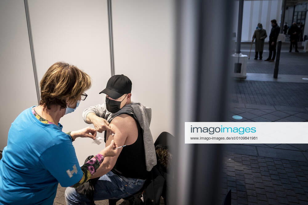 Lasse Spangenberg receives first bite in connection with the first vaccine center in the Capital Region opening in OEksnehallen, at Halmtorvet in Copenhagen, Wednesday 13 January 2021, Copenhagen Denmark