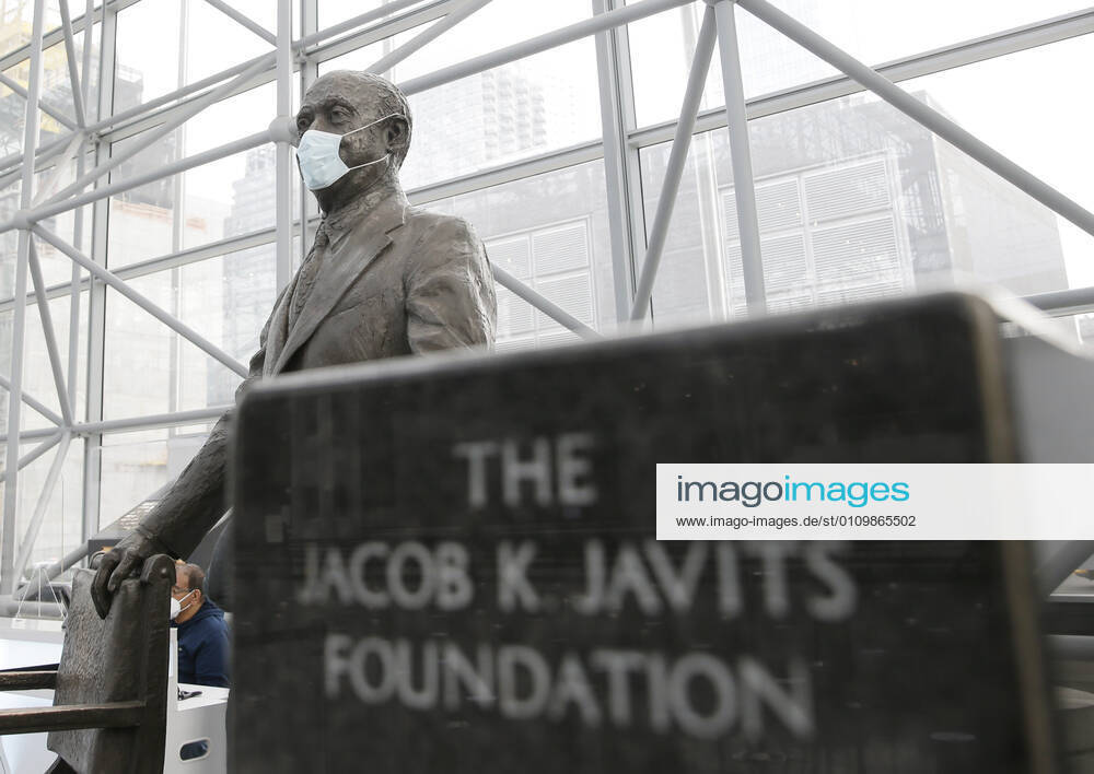 A face mask is on a statue of Jacob K. Javits as patients arrive and go through the check in process to received a COVID-19 vaccination at the Jacob K. Javits Convention Center in New York City on Wednesday, January 13, 2021. The Javits Convention Center which served as a massive field hospital last spring when New York City was the epicenter of the pandemic, now will serve as a huge vaccine distribution center. NYP20210113121 JohnxAngelillo