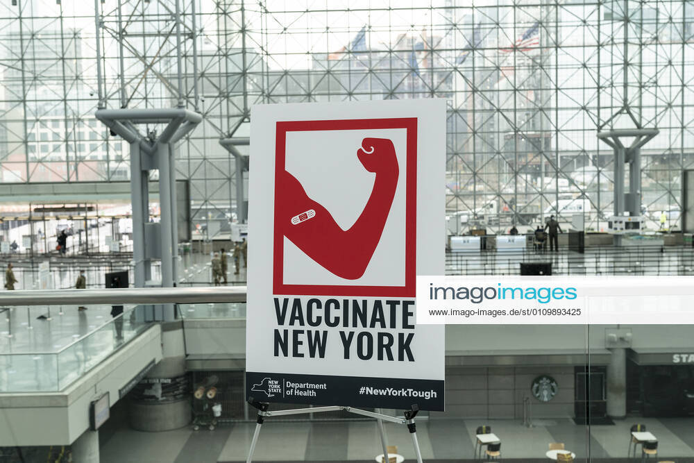 NY: Opening of mass vaccination site at Jacob Javits Center Poster promoting importance of vaccination seen inside of Jacob Javits Center on opening vaccination site. Health care personnel, medical examiners, funeral workers, coroners, essential workers, police officers, firefighters, people older than 65 and more eligible right now to get vaccination in New York State. New York New York United States