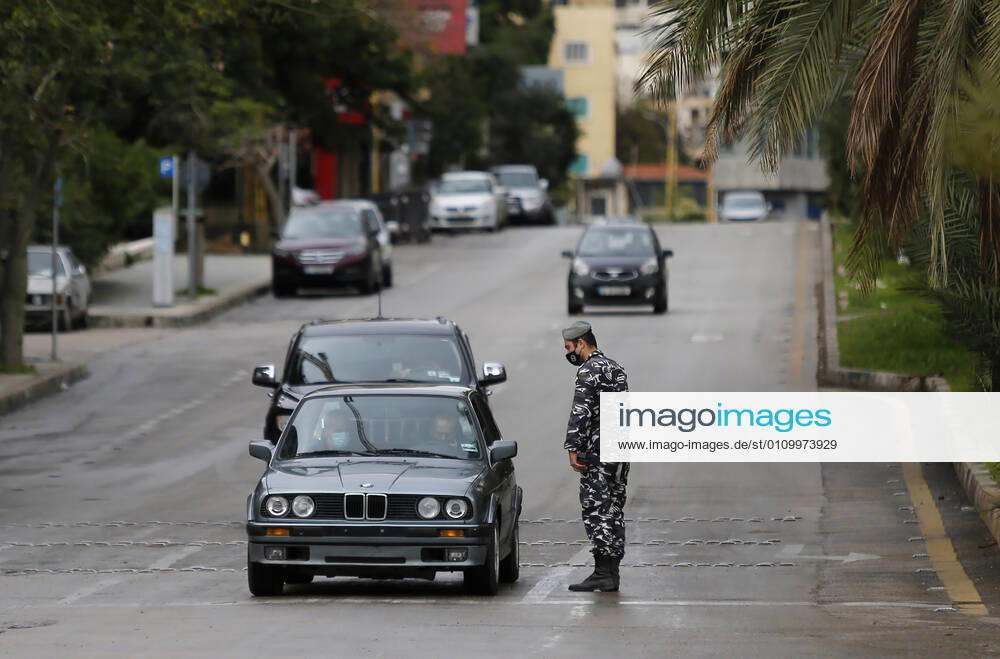 (210114) -- BEIRUT, Jan. 14, 2021 -- A policeman checks a car on a street during a lockdown in Beirut, Lebanon, on Jan. 14, 2021. Lebanon s Higher Defense Council declared a state of emergency between Jan. 14-25 that includes a total lockdown in hope to restrict further spread of COVID-19, Al-Jadeed local TV channel reported. ) LEBANON-BEIRUT-COVID-19-LOCKDOWN BilalxJawich