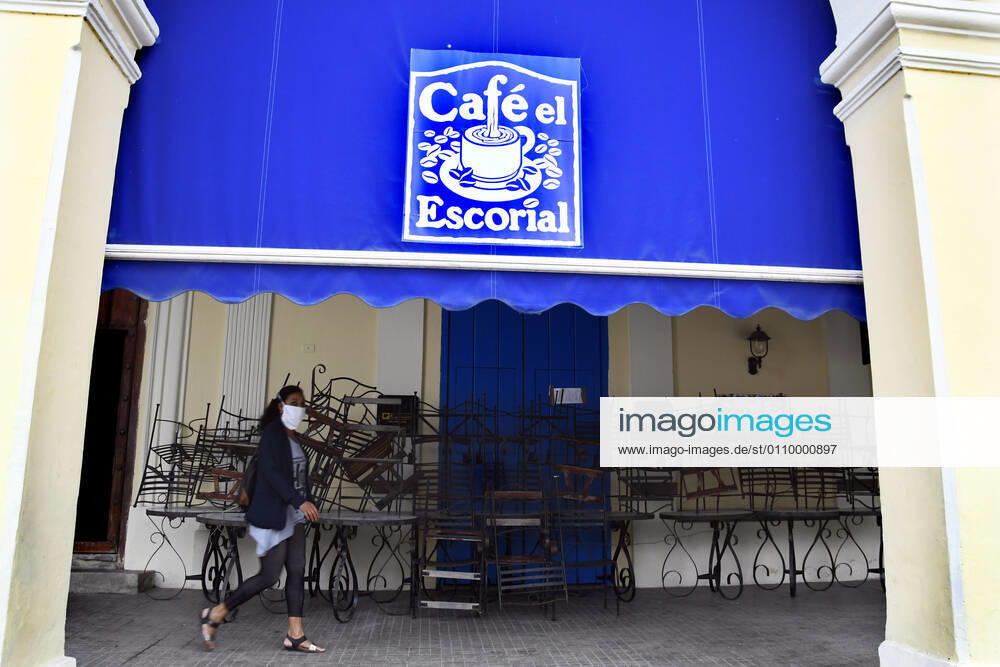 (210115) -- HAVANA, Jan. 15, 2021 -- A woman wearing a face mask walks past a closed cafe in Havana, Cuba, Jan. 14, 2021. Local government in Havana announced new restrictive measures in response to the COVID-19 pandemic as 550 new cases were logged nationwide on Wednesday, setting a new daily record for the sixth day in a row. (Photo by Xinhua) CUBA-HAVANA-COVID-19-CASES JoaquinxHernandez