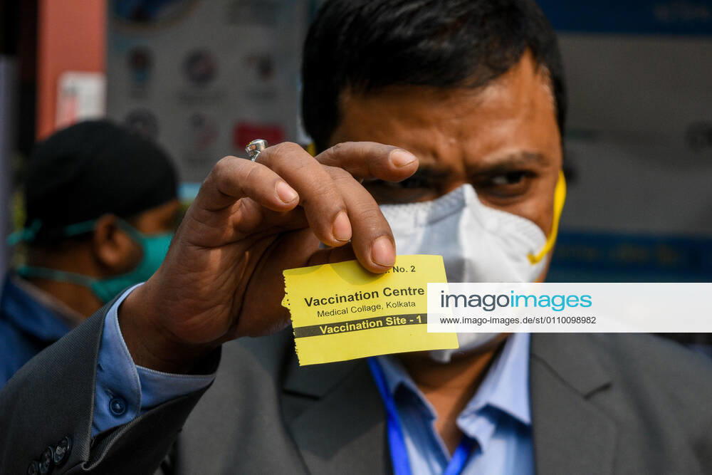 A Doctor shows his entry pass into the vaccination room which was given to him after verification of his identity and registration.With urgent effect , COVID vaccination drives starts in India from 16th of January 2021.The vaccination progrmae are allotted exclusive to the frontline health workers in its first phase of vaccine drive. As of now, COVISHIELD and COVAXIN has been approved by Indian government for use for vaccination. Kolkata India - ZUMAc211 20210116_zip_c211_001