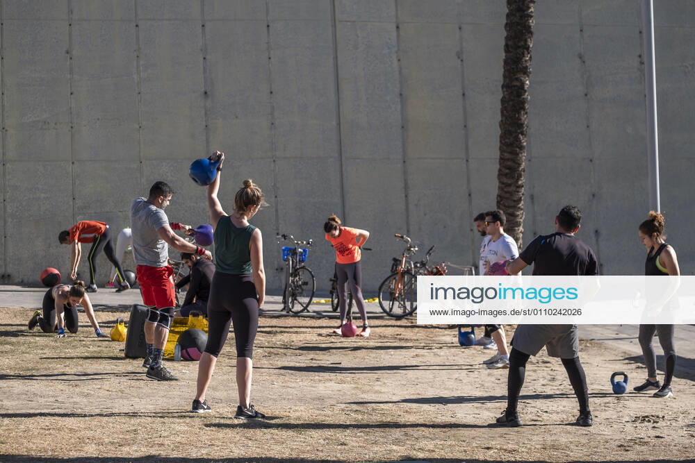 A group of people is seen participating an outdoor gymnastics class on the breakwater of Passeig del Mare Nostrum..With public sports centers and gyms closed due to the increase in Covid-19 infections, many individual and social sports activity is taking place in public space such as open areas near the beaches. Barcelona Spain - ZUMAs197 20210117_zaa_s197_064