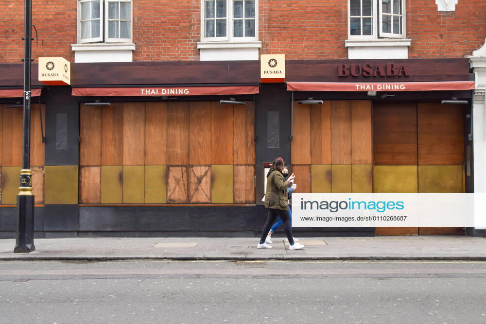 People walk past a closed restaurant in Soho, Central London..England remains under lockdown as the government battles to keep the coronavirus pandemic under control. London United Kingdom - ZUMAs197 20210117_zaa_s197_140