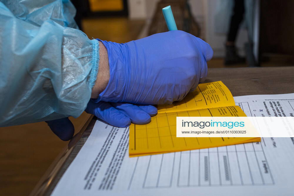 Corona vaccination in a home for the elderly A doctor notes the number of the batch containing the vaccine in the official vaccination card In a home for the elderly, the residents are vaccinated against infection with the coronavirus Two vaccinations are required 21 days apart with the mRNA vaccine from BioNTech to build up the vaccination protection Riet